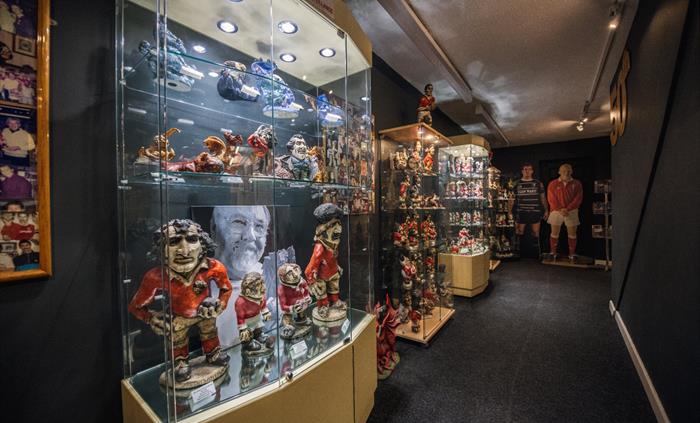 The picture shows a dark room with cabinets showcasing early Groggs.